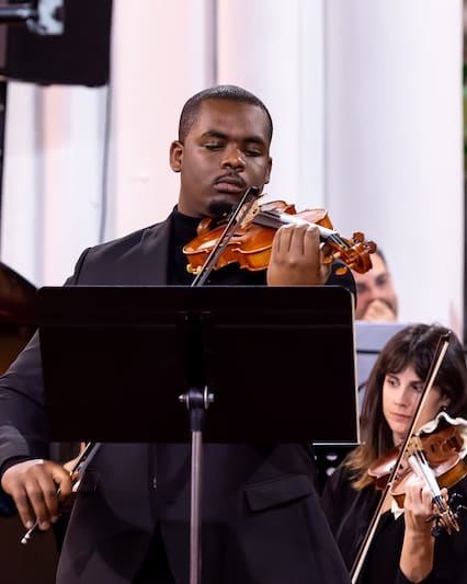 Kieron Daniel playing the violin in performance